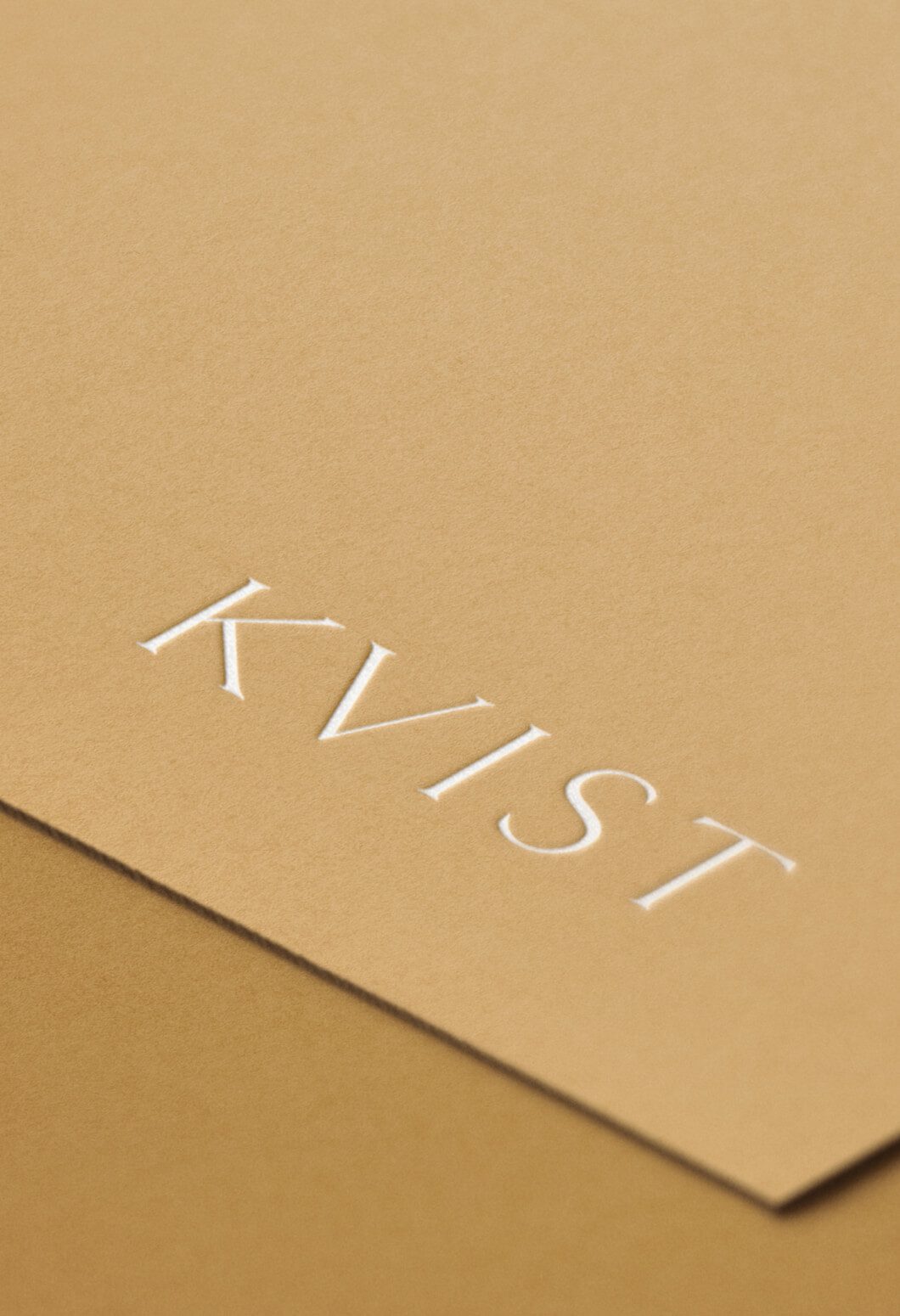 Debossed white logo onto gold stock for, KVIST